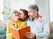 © Lumos sp - grandchild family child grandparent grandmother book reading elderly granddaughter girl  happy together read learning education woman grandfather