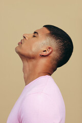 Wall Mural - Man with a glowing and radiant skin tone standing in a studio