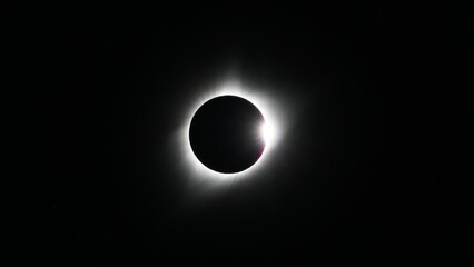 spectacular view of a white smoke eclipse emerging from the moon in close proximity to the sun