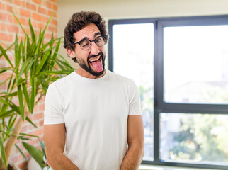 Wall Mural - young adult crazy man with expressive pose at a modern house interior