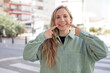 © kues1 - pretty woman smiling confidently pointing to own broad smile, positive, relaxed, satisfied attitude
