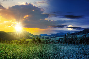 Wall Mural - day and night time change concept. Alpine meadow with tall grass on a background of mountains with sun and moon at twilight