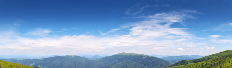 Wall Mural - gorgeous panorama of a blue sky with fluffy clouds. amazing cloudscape above the mountain range on a