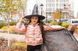 © Angelov - caucasian teenage girl in traditional witch or wizard hat, halloween outside costume, fancy dress party