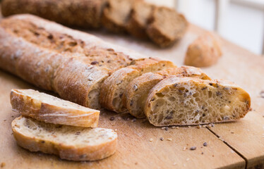 Wall Mural - fresh loaf of bread on wooden board