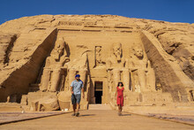 A Tourist Couple Visiting The Abu Simbel Temple In Southern Egypt In Nubia Next To Lake Nasser. Temple Of Pharaoh Ramses II, Travel Lifestyle