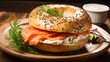 Freshly baked bagel filled with smoked salmon and cream cheese on a wooden board and table. A healthy breakfast food.