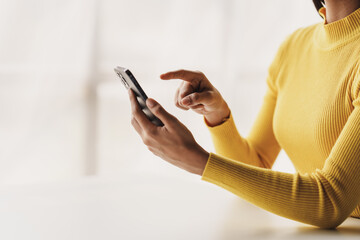 Portrait of a young woman holding a mobile phone to use social media on a smartphone. Communicate via the Internet on a smartphone. concept of using technology in communication