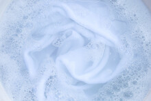 Top View Of Towel Soak In Powder Detergent Water Dissolution. Laundry Concept
