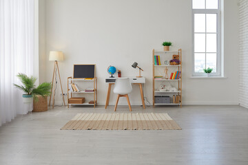 Children's study room at home. Modern spacious interior with desk, chair, bookshelves, chalkboard, lamps, Earth globe, plants, boxes, toys, rug, and laminate flooring. Unisex design for boy or girl