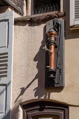 Wall Mural - Obernai, France - 06 24 2023: City of Barr. View of a typical old water pump Alsatian in a village.