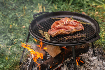 Wall Mural - Beef steaks on the grill with flames, banner, menu, recipe place for text, top view