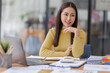 © David - Business asian women working on laptop in office, calculating income-expenditure and analyzing real estate investment data, Accounting Financial and tax systems concept.