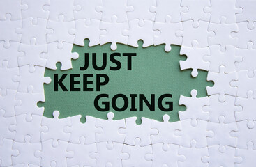 Just keep going symbol. White puzzle with words Just keep going. Beautiful grey green background. Business and Just keep going concept. Copy space.
