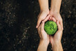 World Earth Day Concept.Hands of People Embracing green earth. G