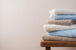 Stack of blue white beige cotton terry towels close up view. Bathroom interior details with copy space
