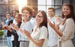 © Katsiaryna - High angle view of multiethnic people cheering after a seminar