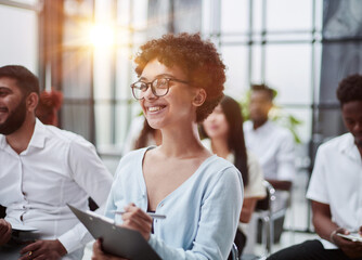 Group of different employees studying at board meeting in modern office or conference room