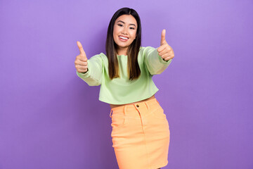 Sticker - Photo of nice confident lady wear green sweatshirt smiling showing two thumbs up isolated purple color background