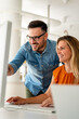 © NDABCREATIVITY - Happy couple doing business together working at small office