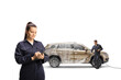 © Ljupco Smokovski - Female carwash worker writing a document and a man washing a SUV with pressure washer