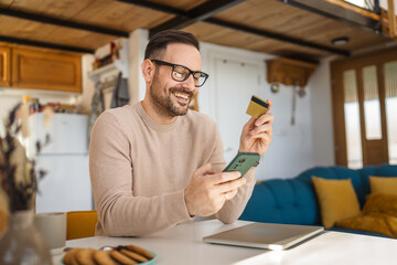 One man caucasian male online shopping use laptop and hold credit card