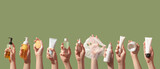 Korean care system cosmetic bottles, jars, tubes green background. Peeling, cleansing oil, mask, foam, toner, shit mask, sun cream