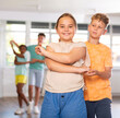 © JackF - European boy and girlie learn figures of pair dance and train before competition. Children fitness group is engaged in studio