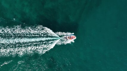 Wall Mural - Vacation and leisure. Aerial view on fast boat on blue Mediterranean sea at sunny day. Fast ship on the sea surface. Seascape from the drone. Seascape from air. Seascape with motorboat.
