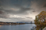 Fototapeta Desenie - Panorama of the rhine river in Bonn, at dusk with cruiseships on the waterfront. Bonn is a major city of Nordrhein Westfalen, in Germany, and the former German capital city.