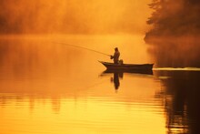 A Man Is A Fisherman On A Fishing Trip. Background With Selective Focus And Copy Space