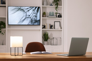 Sticker - Cosy workplace near tv area with shelves. Interior design