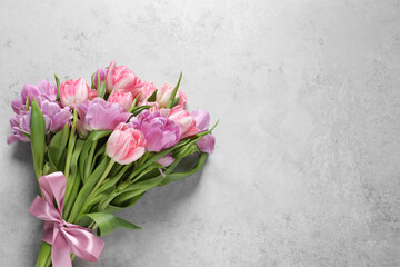 Wall Mural - Beautiful bouquet of colorful tulip flowers on light gray table, top view. Space for text