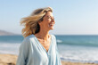 © MVProductions - Blissful smiling woman on a beach vacation, smiling broadly with joy, enjoying her long awaited holidaysBlissful smiling woman on a beach vacation, smiling broadly with joy, generative ai