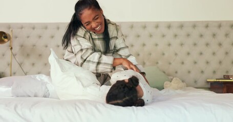 Wall Mural - Pillow fight, bedroom and mother tickling her child with love, care and playful expression at their home. Happy, smile and young mom playing and bonding with her girl kid on bed in their family house