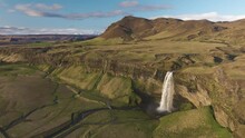 Scenic Seljalandsfoss Waterfall With The View Of Icelandic Plateau, Mountain Peak And Valley, Iceland, Aerial Shot