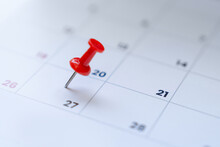 Embroidered Red Pins On A Calendar Event Or Travel Planning Concept.