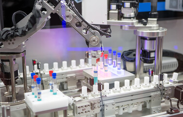 Automated process in laboratory. Robot arm with test tube virus in laboratory.