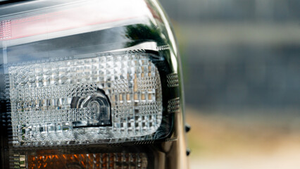 Wall Mural - Close up back side of tail light of car. Blurred of wall for background.