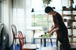 © hideo tsuto - 開店前のカフェで花をいける日本人女性