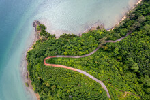 Top View Of Countryside Road Passing Through The Green Forrest And Mountain