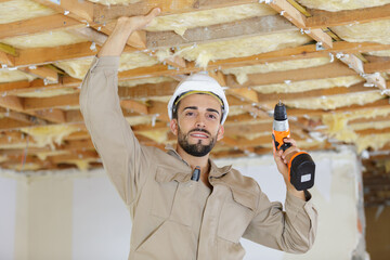 portrait of workman holding cordless drill