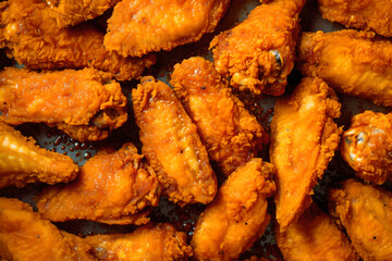 Fried chicken wings with crispy crust background top view