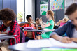 © WavebreakMediaMicro - Happy, diverse female school teacher and schoolgirl practicing sign language in class