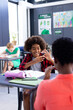 © wavebreak3 - Vertical of african american female school teacher and boy using sign language in class