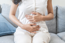 Flatulence Ulcer, Asian Young Woman, Girl Hands In Belly, Stomach Pain From Food Poisoning, Abdominal Pain And Digestive Problem, Gastritis Or Diarrhoea. Abdomen Inflammation, Menstrual Period People.