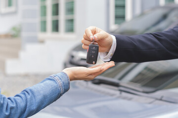 Business car rental, sell or buy service, dealership hand of agent dealer, sale man giving auto key of vehicle to customer renter, buyer young woman receiving, client or tenant, transfer automobile.