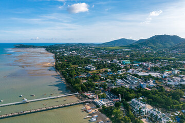 Wall Mural - Aerial view landscape of Chalong City at sea port. Boats parked on the beach with city view by drone. Aerial view of Chalong bay at Phuket, Thailand.