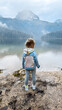 girl looking on the beautiful Lake with mountains on background