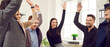 © Studio Romantic - Unity and teamwork. Positively motivated business team joyfully raises their hands as sign of their successful work and synergy. Colleagues in office celebrate their success together. Web banner.